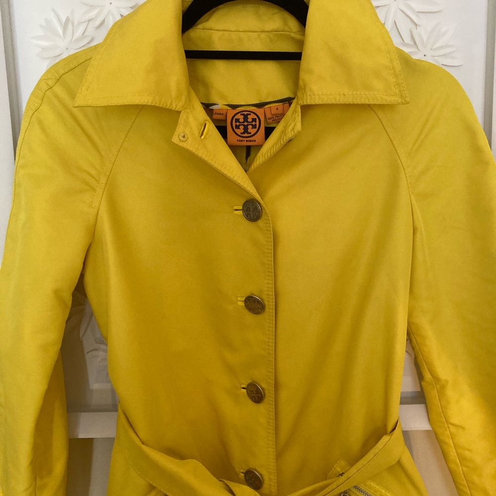 Tory Burch yellow button down trench/rain coat with belt and zip pockets.